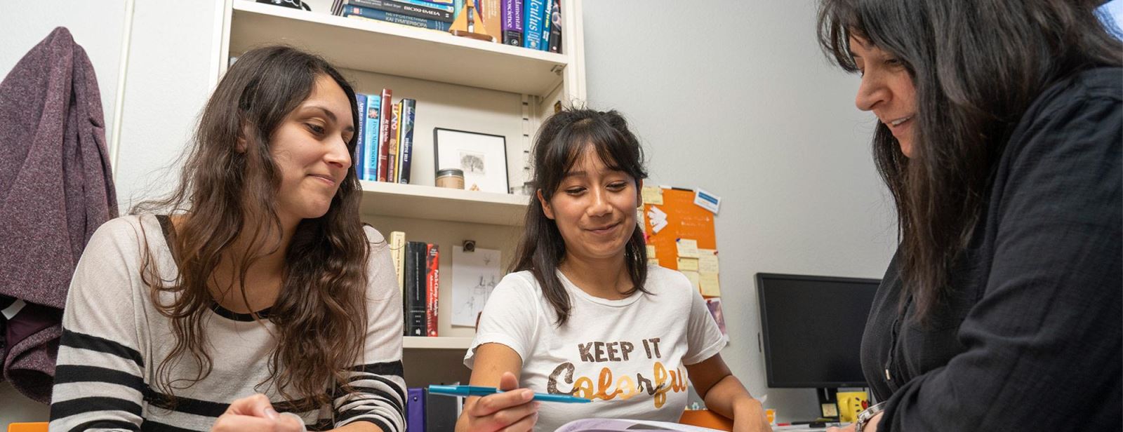 Counselor assisting two college students